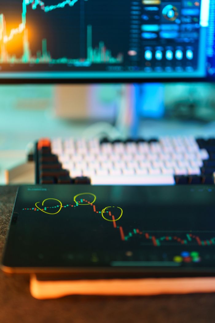 Visual of cryptocurrency trading screens displaying market analysis and candlestick charts.